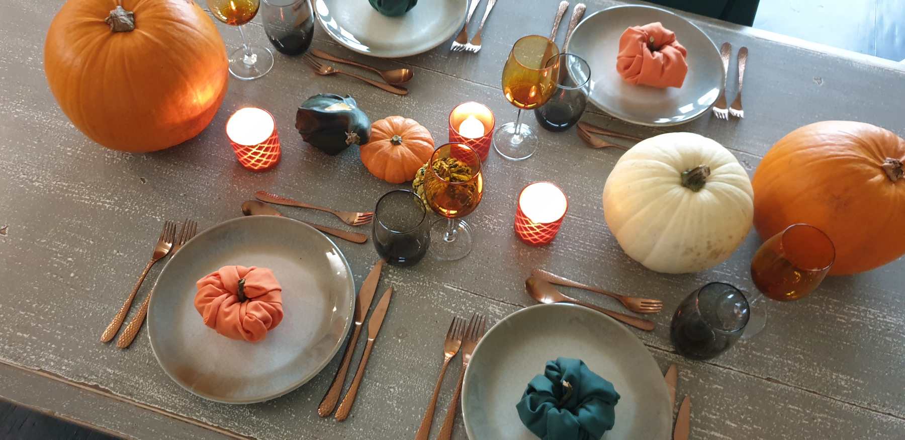 Halloween table setting with napkins shaped like pumpkins