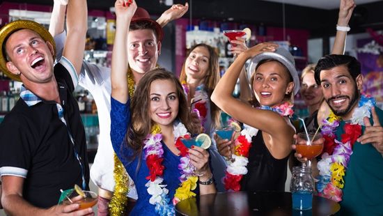 A group of people in football shirts celebrating a match