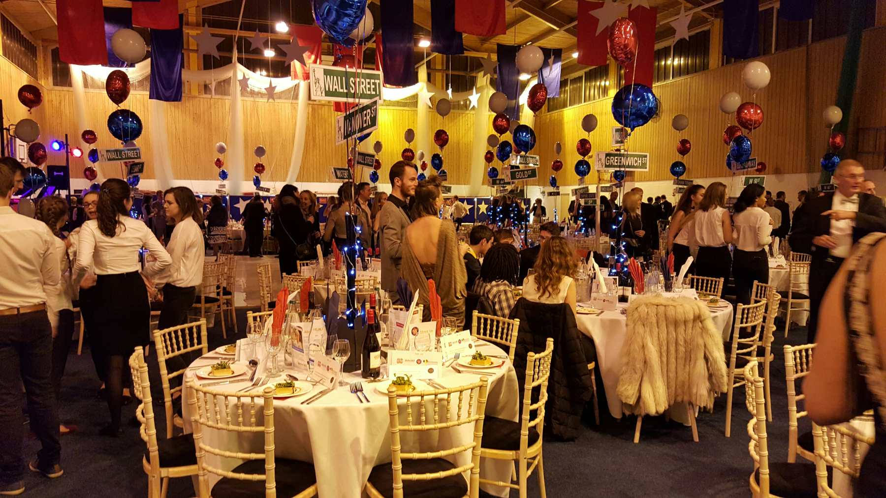 A function room dressed spectaculalry in red, white and blue for a company dinner.