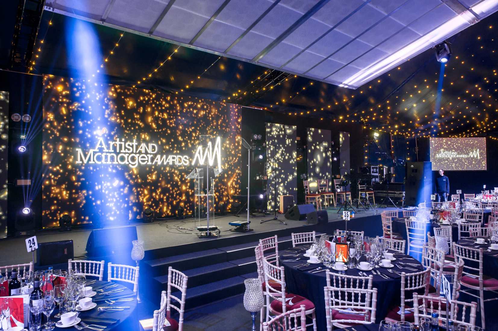 Glamorous black and silver room with stage set up for company rewards and recogniton events