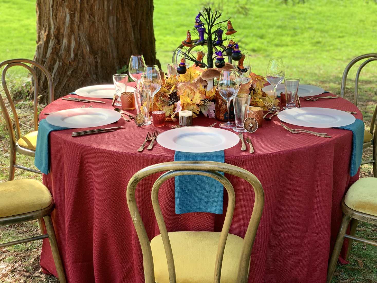 A table set for Halloween in a forest.