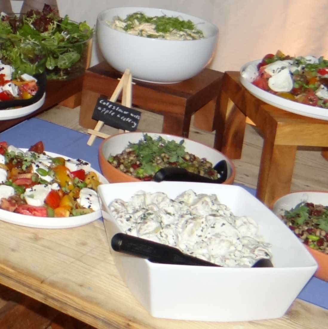 A selection of salads and finger food items at a buffet table at a celebration of life.