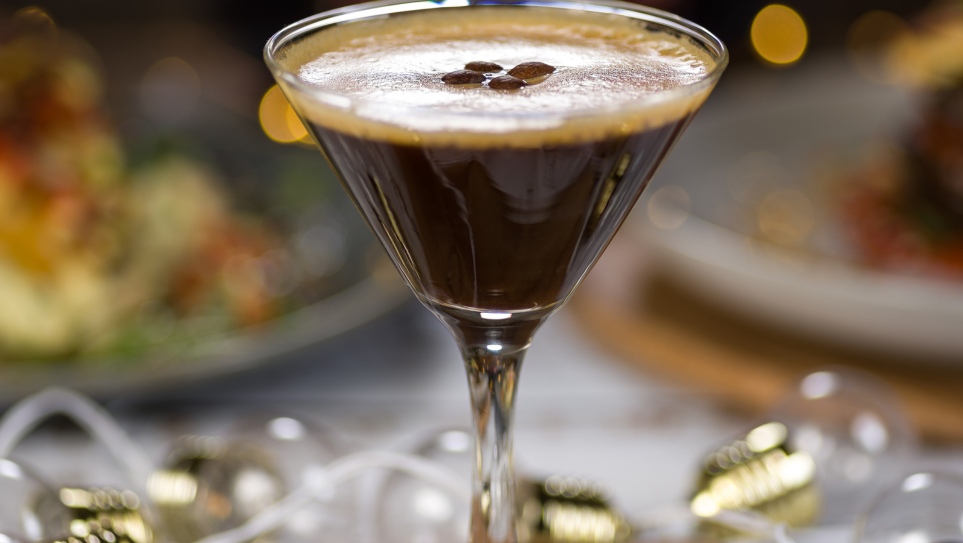 A glass of Espresso Martini on a wedding table.