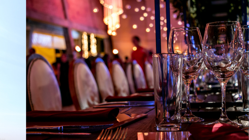 A dressed table and sparkly backdrop at an event.