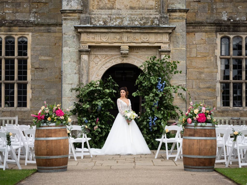 A bride in the entrance of a manor house