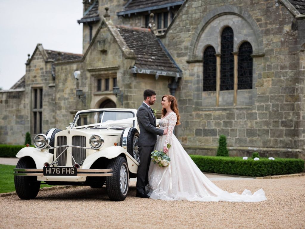 A vintage wedding car with bride and groom