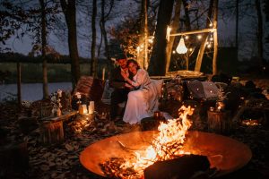 Bride & Groom Huddle by a Campfire