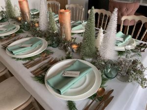 A Celadon Christmas table setting in white, green and cream.