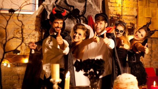 Group of young adults celebrating Halloween in fancy dress.
